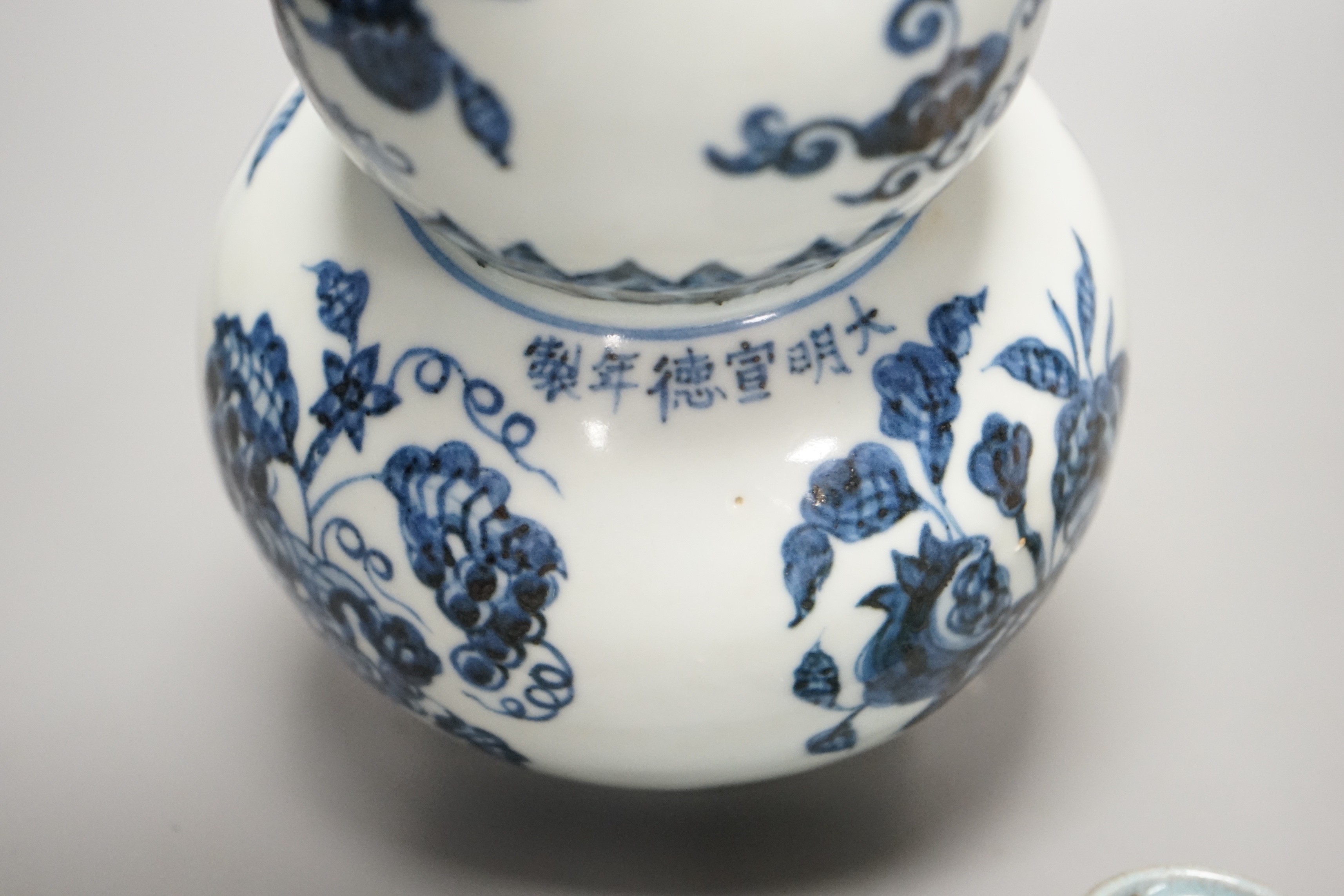 A Chinese blue and white double gourd vase, a Jun-type cup and a small baluster vase